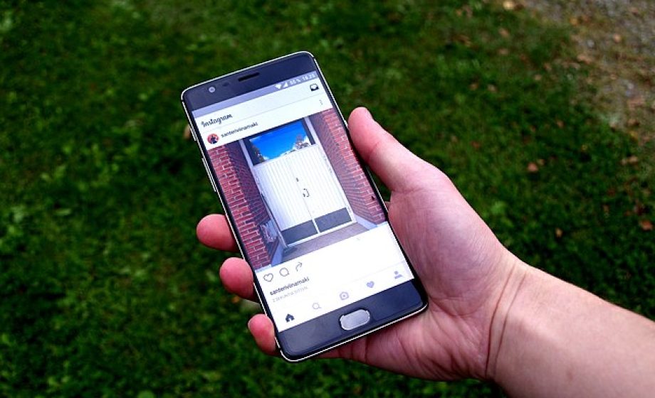 Instagram app on smartphone (grass background)